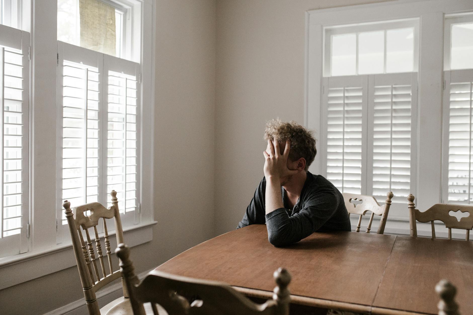 Processing Traumatic Memories: photo of man leaning on wooden table